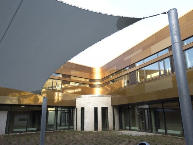 Med Fjelsøs facade på Vejle Psyk, skaber arkitektur og natur en flot sammensætning.